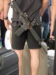 Soldier with his gun in the hotel.